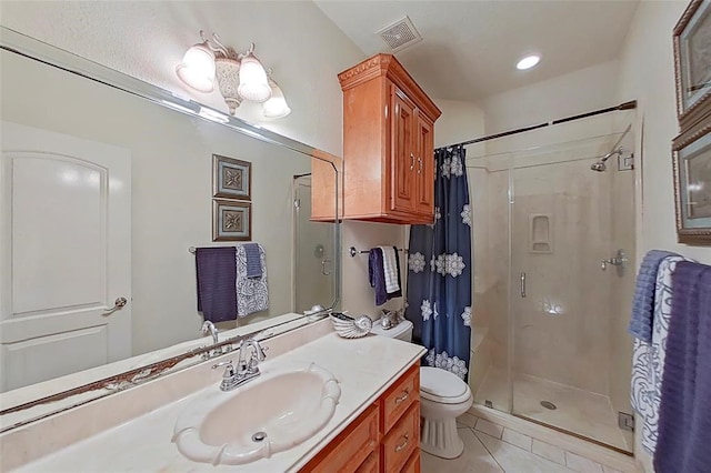 bathroom featuring curtained shower, toilet, tile floors, and vanity with extensive cabinet space