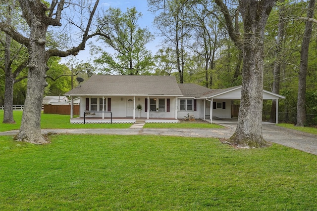 ranch-style home featuring a front yard, a porch, and a carport