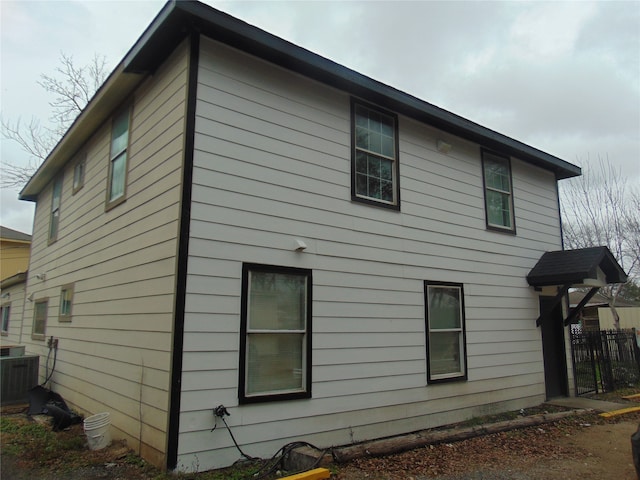 view of side of home with central air condition unit