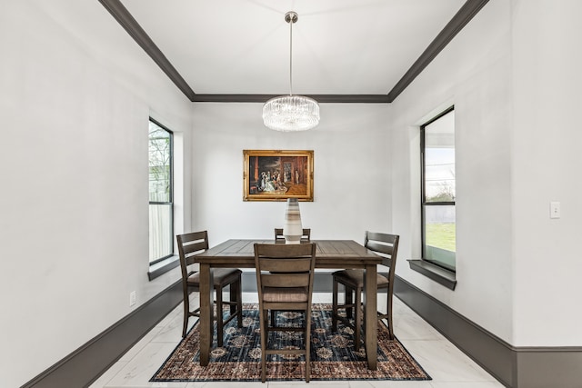 dining room featuring ornamental molding, a chandelier, marble finish floor, and baseboards