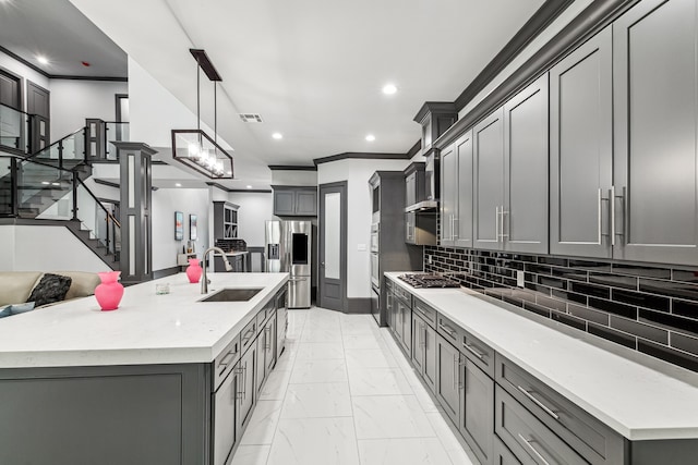 kitchen featuring gray cabinets, stainless steel appliances, and a sink