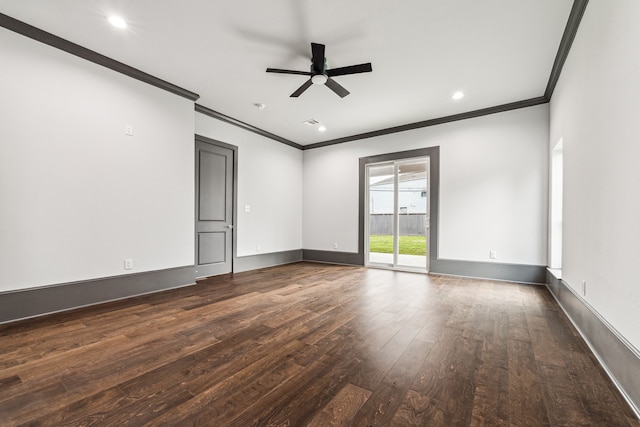 spare room featuring dark wood-style floors, a ceiling fan, baseboards, and crown molding