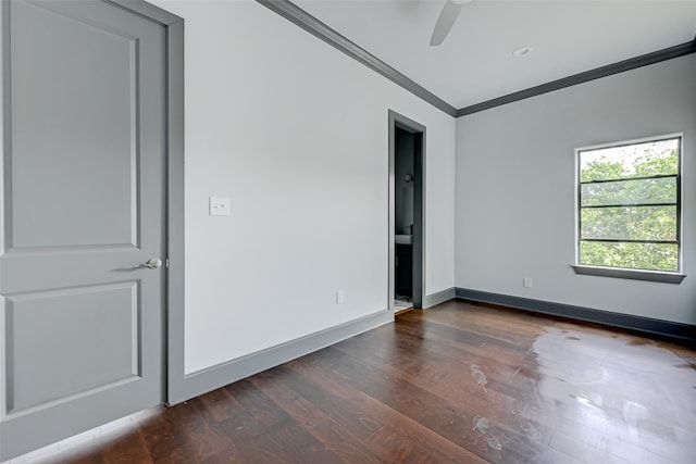 unfurnished room with baseboards, dark wood-style flooring, a ceiling fan, and crown molding