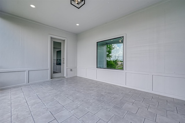 empty room with recessed lighting and a decorative wall