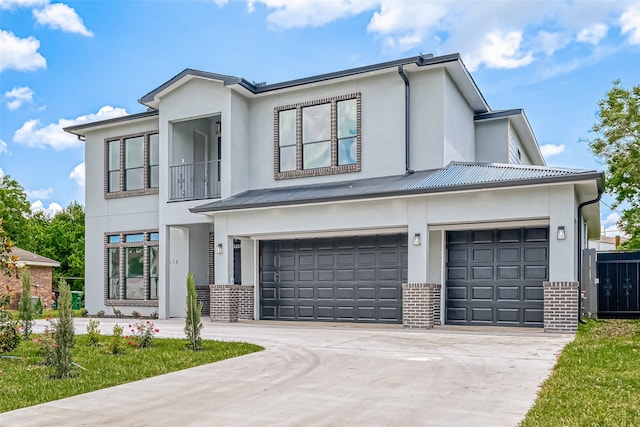 view of front facade featuring driveway, stucco siding, and brick siding