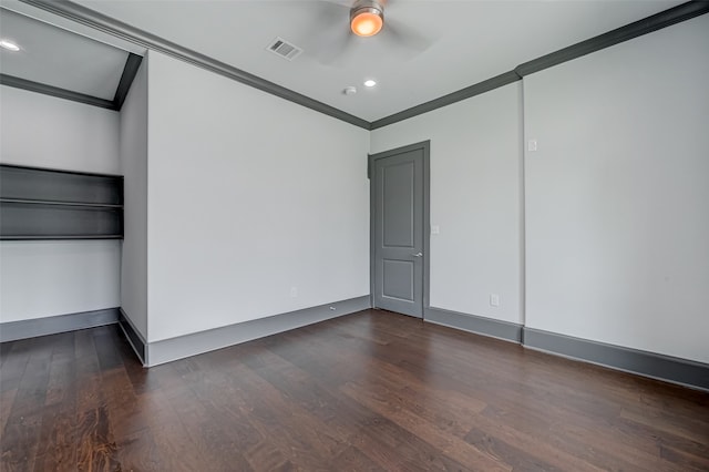 empty room with a ceiling fan, visible vents, dark wood-style flooring, and crown molding