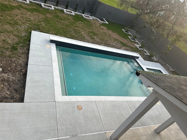 outdoor pool featuring a yard and a fenced backyard