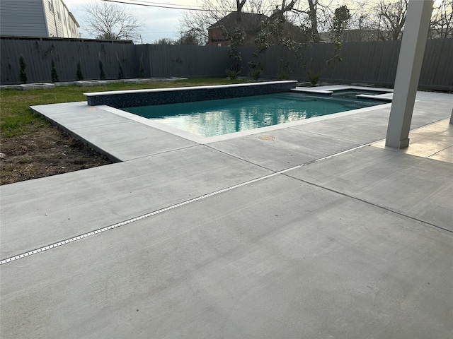 view of swimming pool with a fenced backyard, a fenced in pool, and a patio