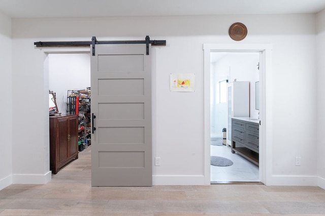 interior space featuring a barn door and light hardwood / wood-style flooring