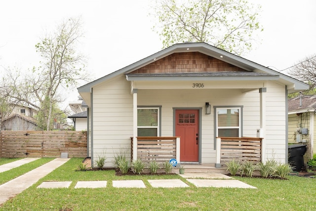 bungalow featuring a porch and a front lawn