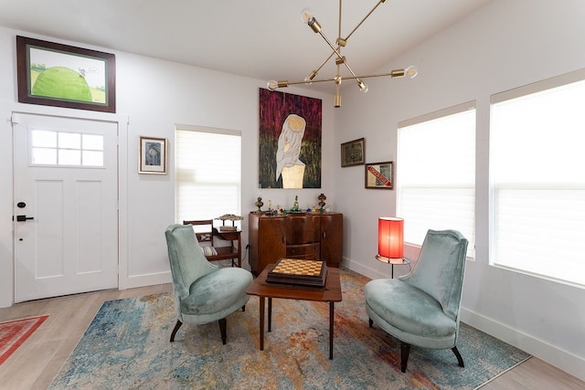 living area with a chandelier and light hardwood / wood-style floors