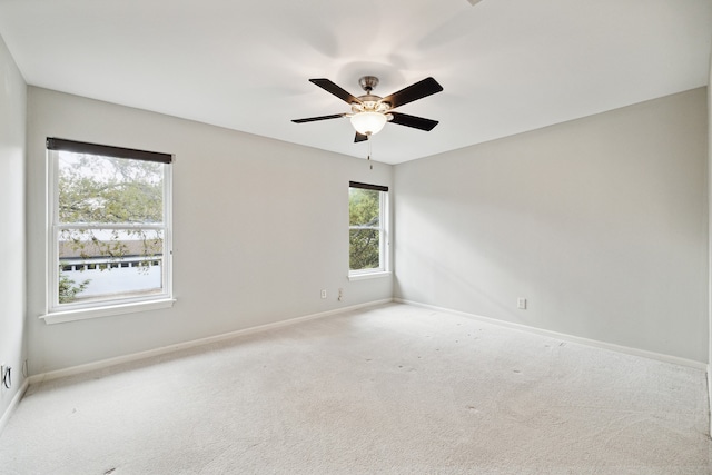 carpeted empty room featuring ceiling fan