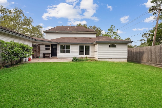 back of house with a lawn