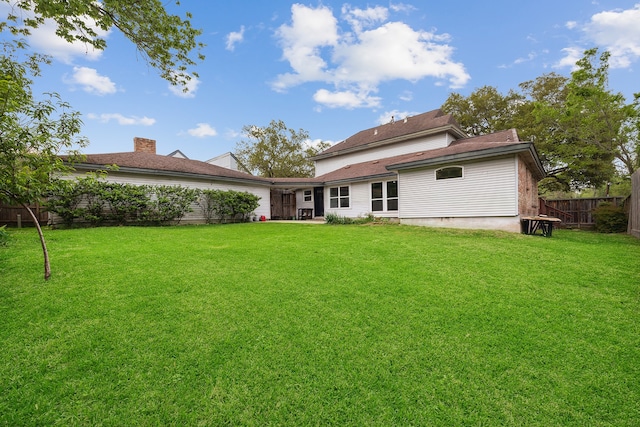 back of house featuring a lawn