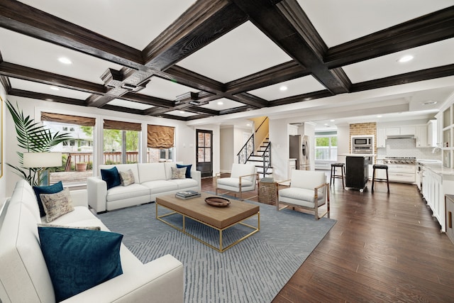 living room with crown molding, dark hardwood / wood-style floors, beam ceiling, coffered ceiling, and sink