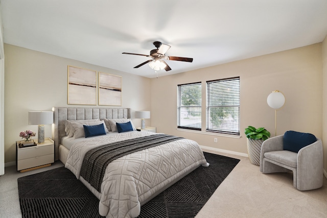 bedroom with ceiling fan and light carpet