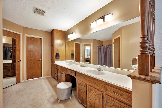 bathroom featuring vanity and a textured ceiling