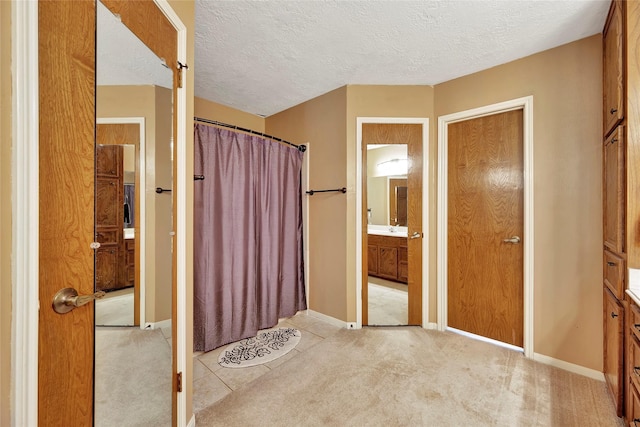 bathroom with vanity and a textured ceiling