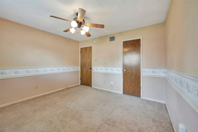 interior space featuring ceiling fan and a textured ceiling