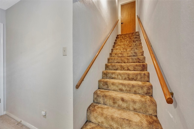 stairs featuring carpet flooring