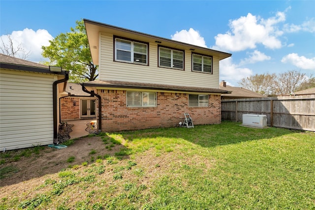 rear view of property with a yard