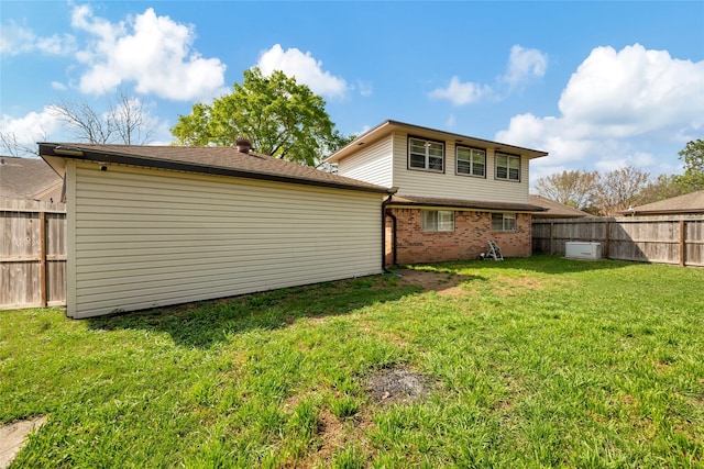 back of property featuring a lawn