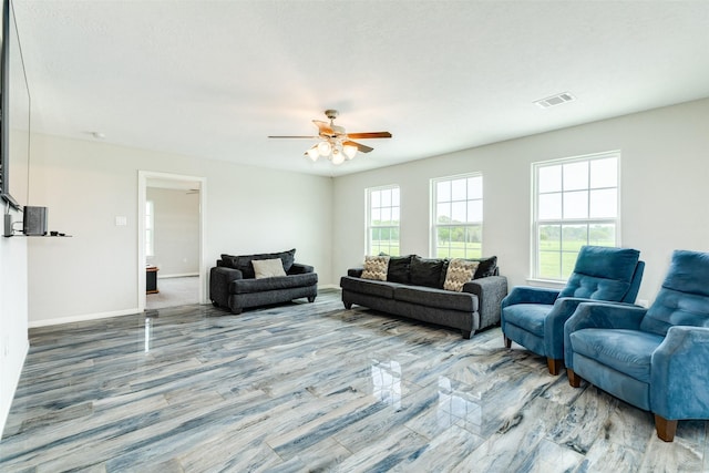 living room with a textured ceiling and ceiling fan