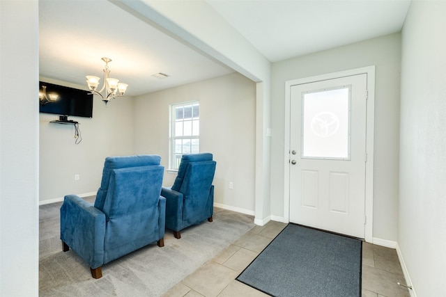 entryway with a chandelier and light tile patterned floors