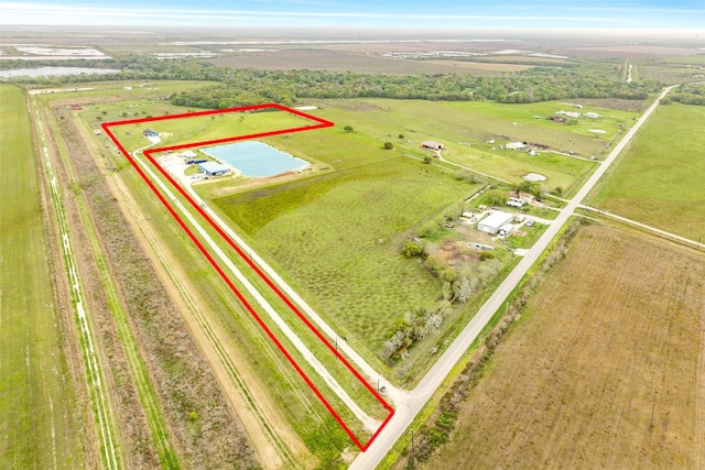 birds eye view of property featuring a rural view and a water view