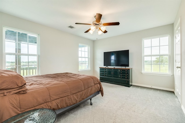 bedroom featuring light carpet and ceiling fan