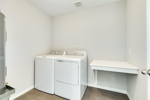 laundry area featuring washer and clothes dryer and tile patterned floors