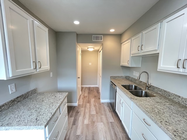 kitchen featuring white cabinetry, light stone counters, sink, and light wood-type flooring