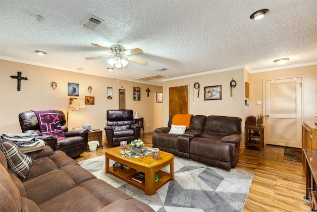 living room featuring ceiling fan, crown molding, light wood-type flooring, and a textured ceiling