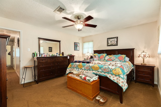 bedroom with carpet flooring, ceiling fan, and a textured ceiling