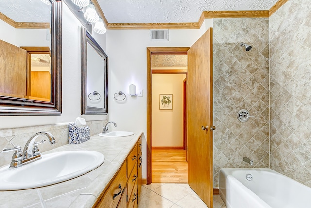 bathroom featuring tile patterned flooring, vanity, ornamental molding, and a textured ceiling