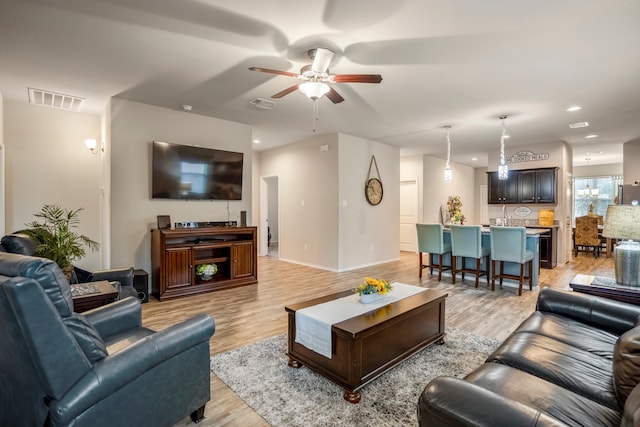 living room with ceiling fan and light hardwood / wood-style floors