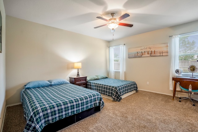 bedroom featuring ceiling fan and carpet