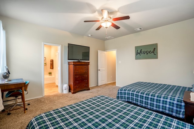 bedroom featuring ceiling fan, ensuite bathroom, and light carpet