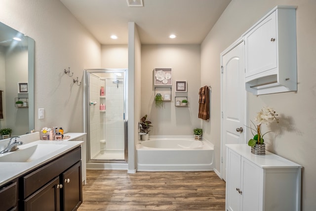 bathroom featuring wood-type flooring, vanity, and independent shower and bath