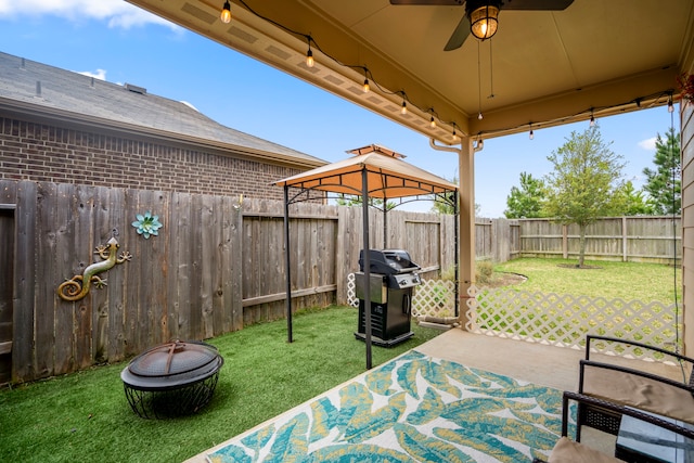 view of patio featuring a gazebo, grilling area, and ceiling fan