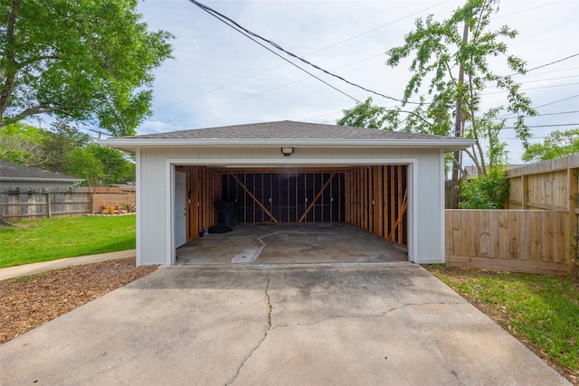 detached garage featuring fence