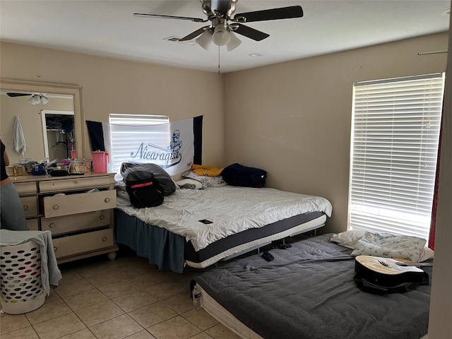 tiled bedroom with ceiling fan