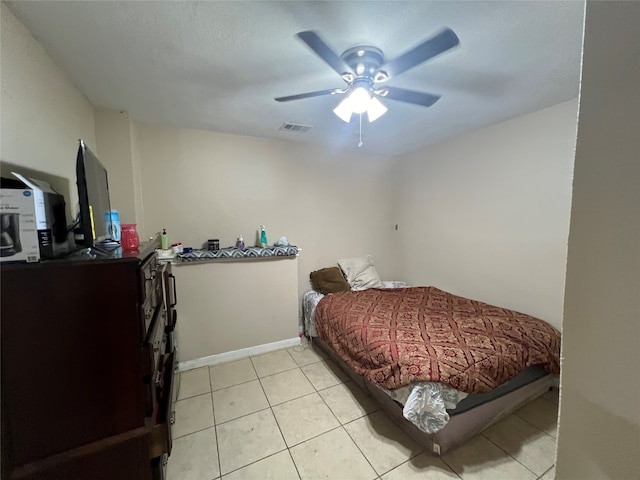 bedroom featuring light tile floors and ceiling fan