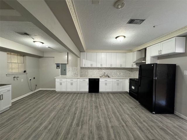 kitchen featuring black appliances, sink, light wood-type flooring, a textured ceiling, and wall chimney range hood