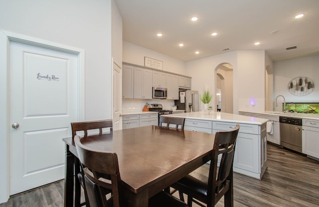 dining space with sink and dark hardwood / wood-style flooring