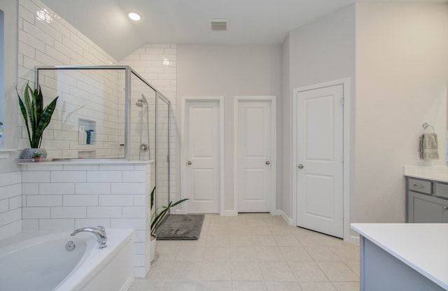 bathroom featuring vanity, shower with separate bathtub, tile floors, and lofted ceiling