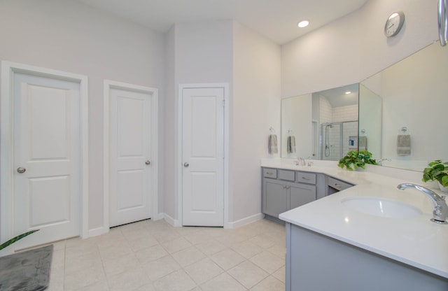 bathroom featuring tile floors and dual vanity