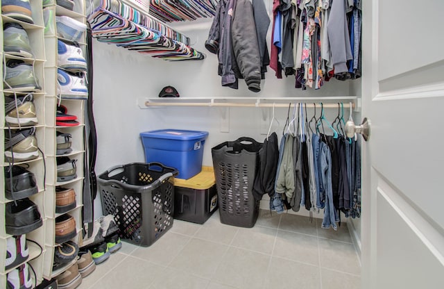 spacious closet with light tile floors