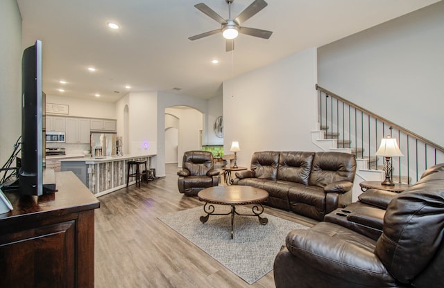 living room featuring ceiling fan and light wood-type flooring