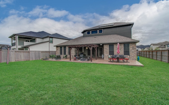 back of property featuring a lawn and a patio